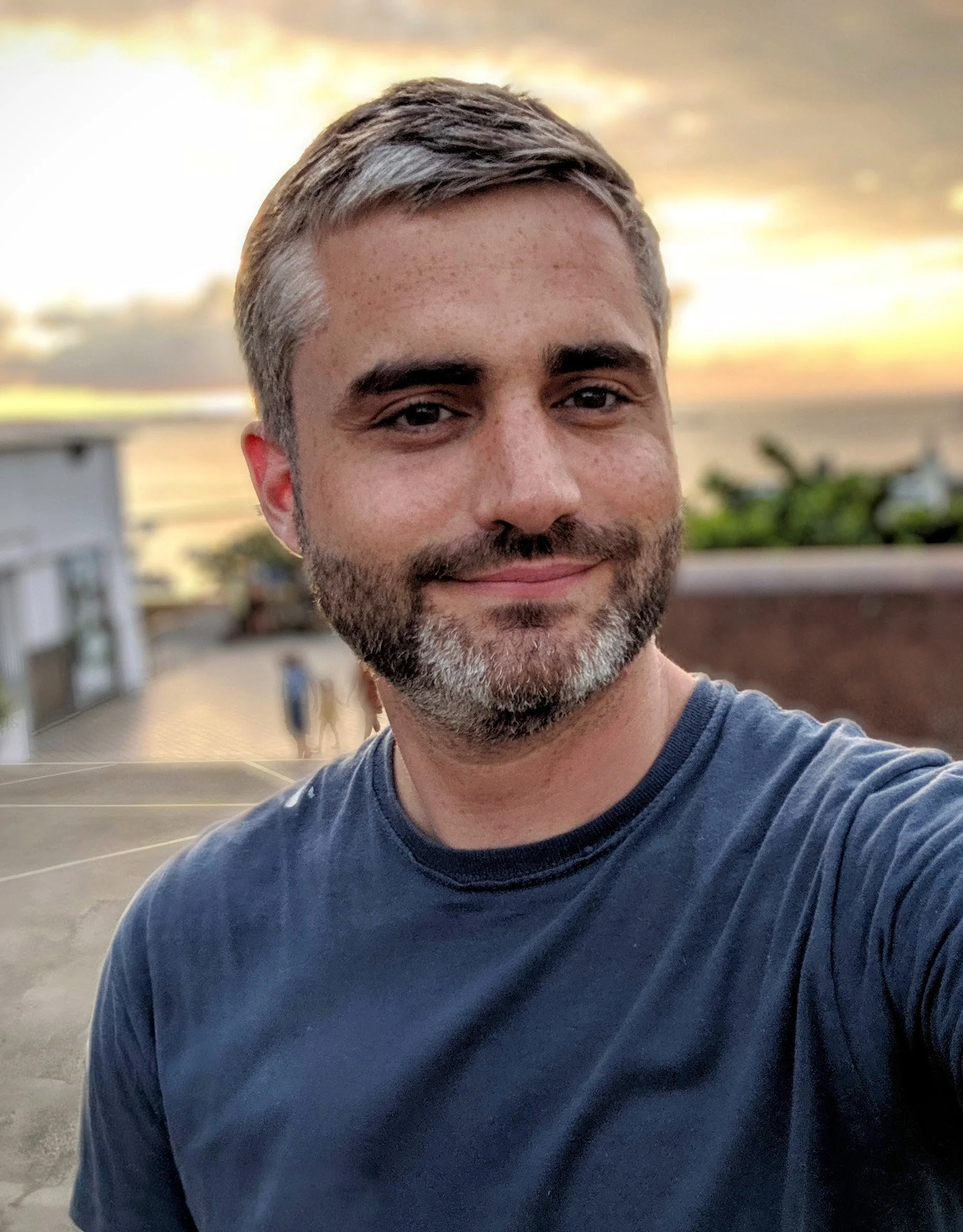 Portrait of Coridon Bratton smiling outdoors at sunset