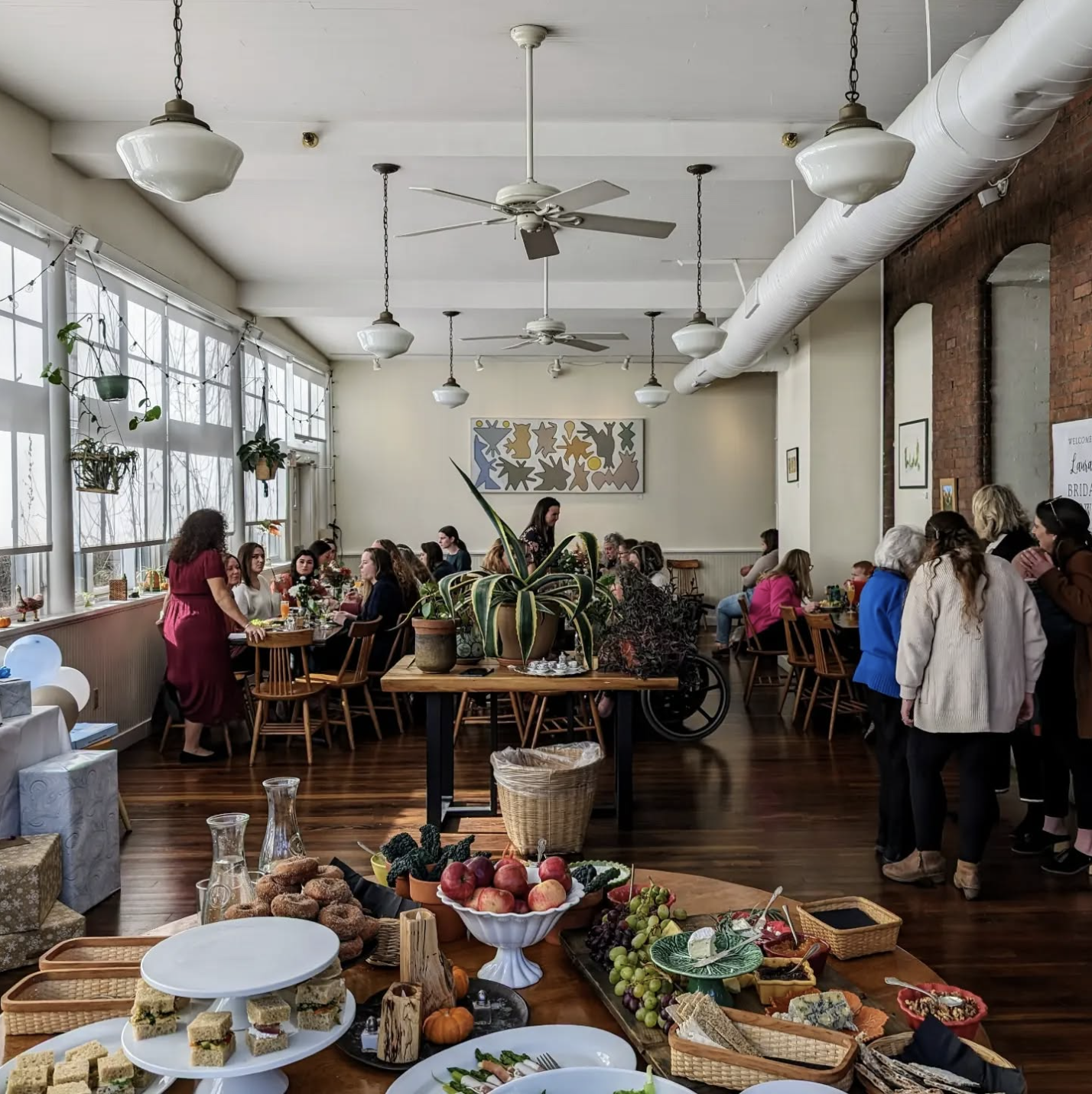 Gathering at A Vermont Table with seasonal spread and guests in a light-filled room