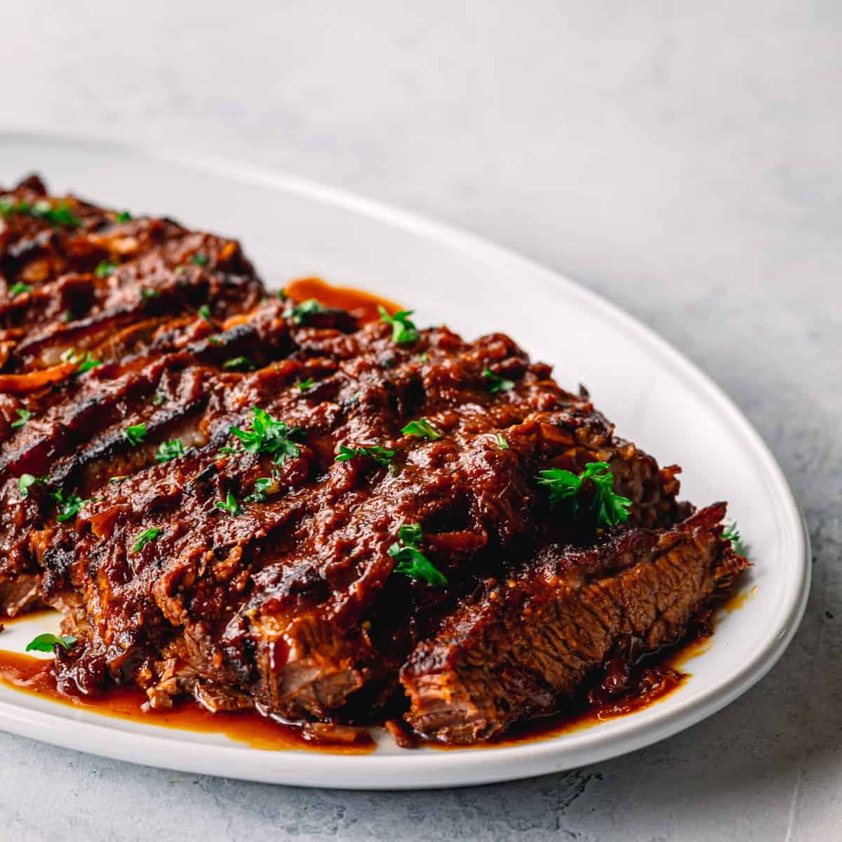 Sliced braised beef brisket in red wine jus